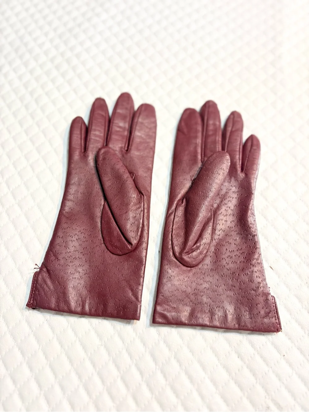 maroon leather gloves feature a distinctive textured perforated pattern 6.5